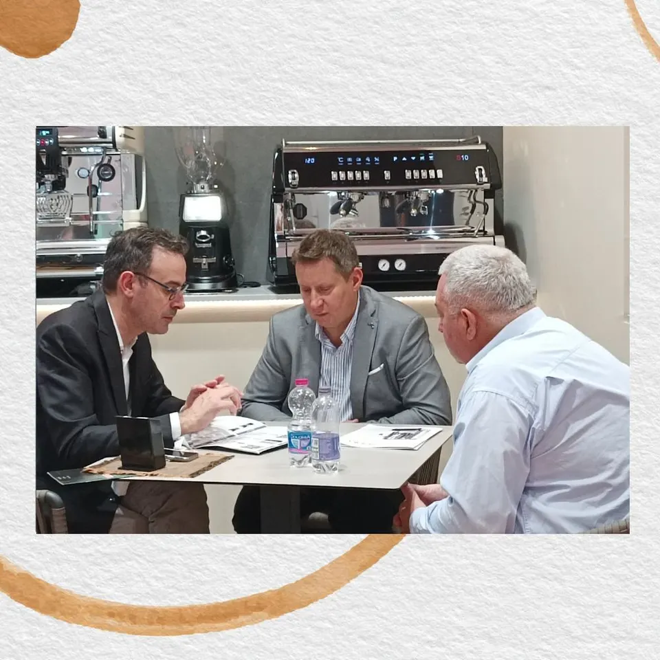 Three people at a table during a meeting