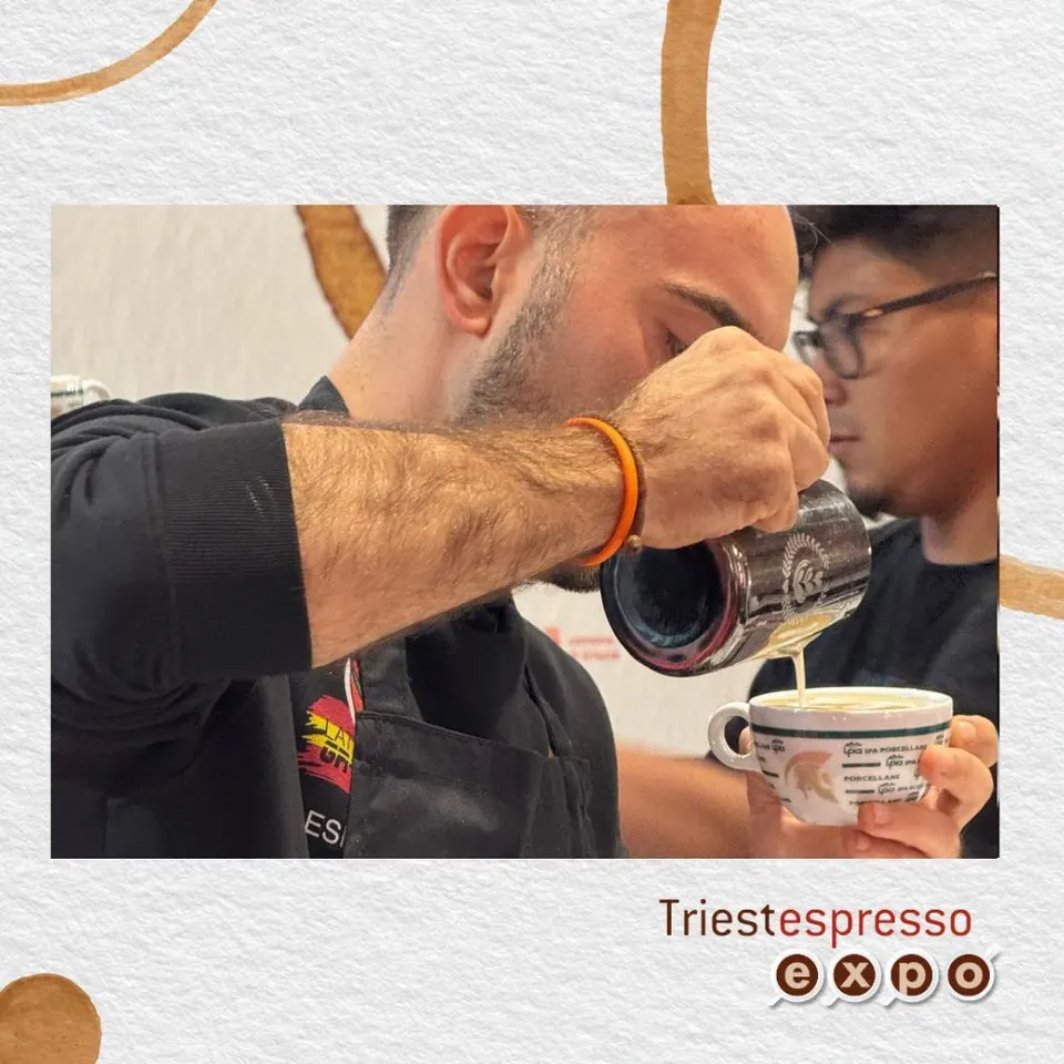 A barista pouring milk for latte art