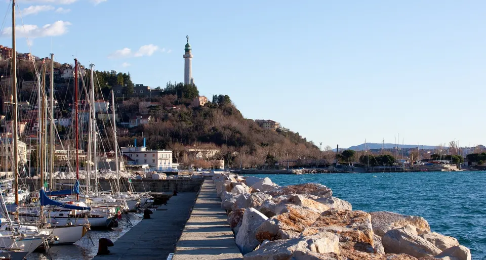 Moored boats with a lighthouse in the background